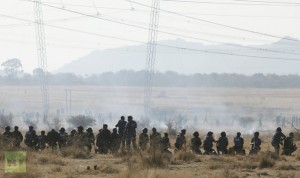 Policemen fire at striking miners outside a South African mine in Rustenburg